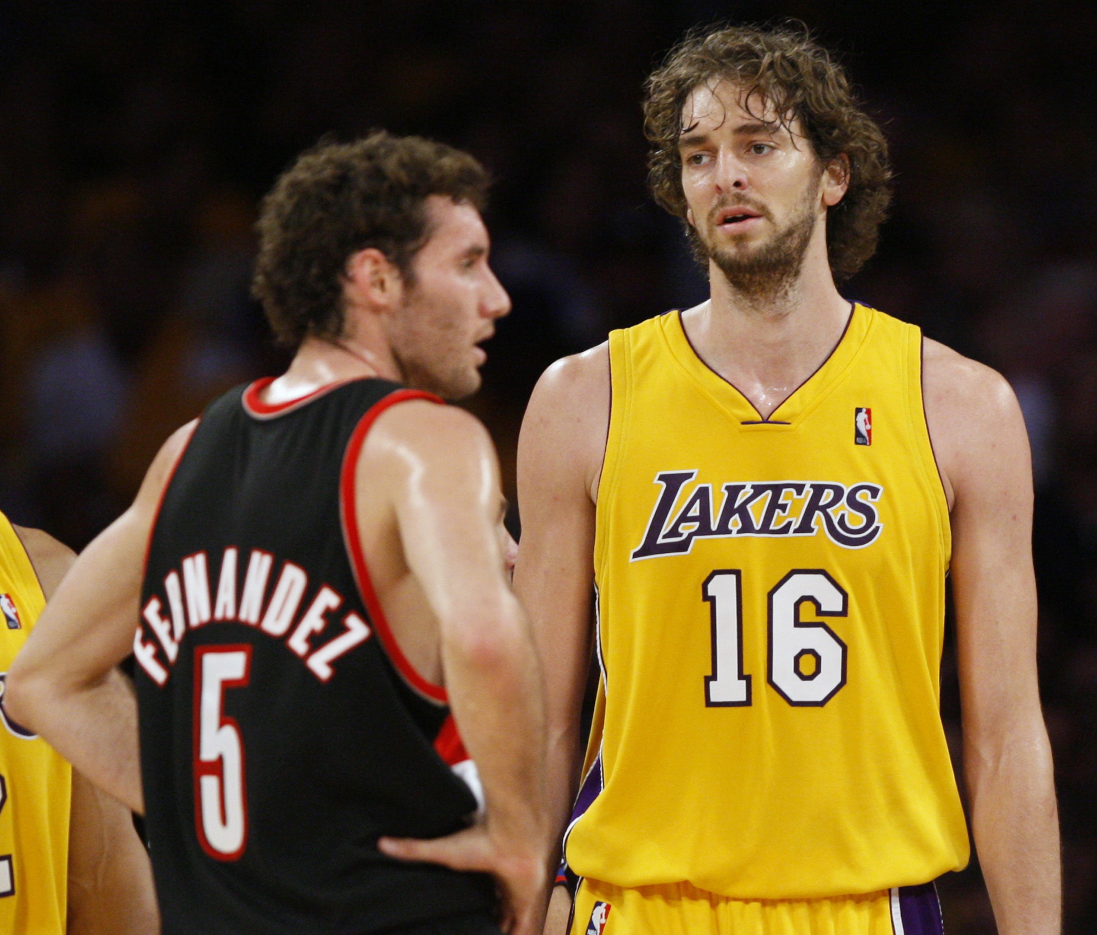 DOCU_QUE Los Angeles Lakers Pau Gasol of Spain walks past compatriot Rudy Fernandez during their NBA basketball game in Los Angeles